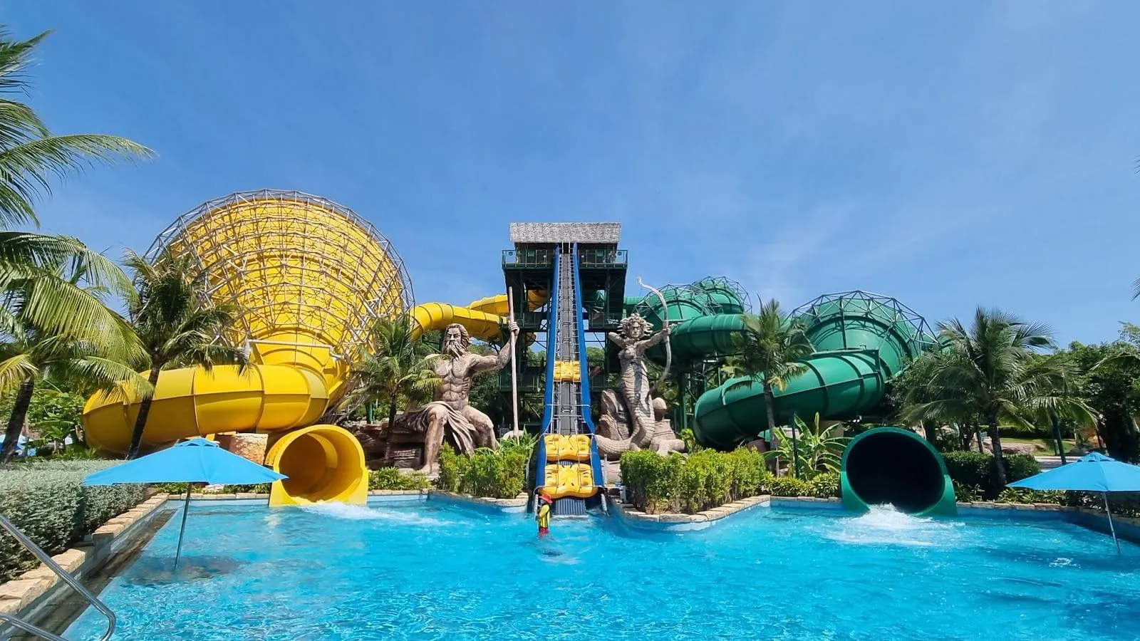 Yellow and green water slides and a pool at Aquatopia water park on Hon Thom island