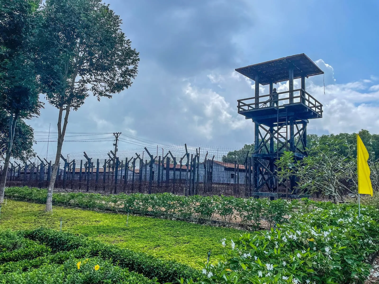 A watchtower and barbed-wire fence at the Phu Quoc Prison historic site
