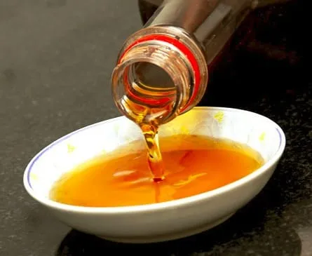 Golden-brown Phu Quoc fish sauce poured into a white bowl