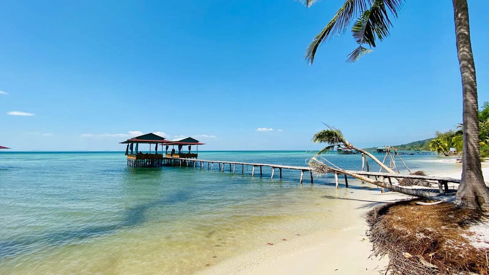 A wooden pier over turquoise water at Rach Vem