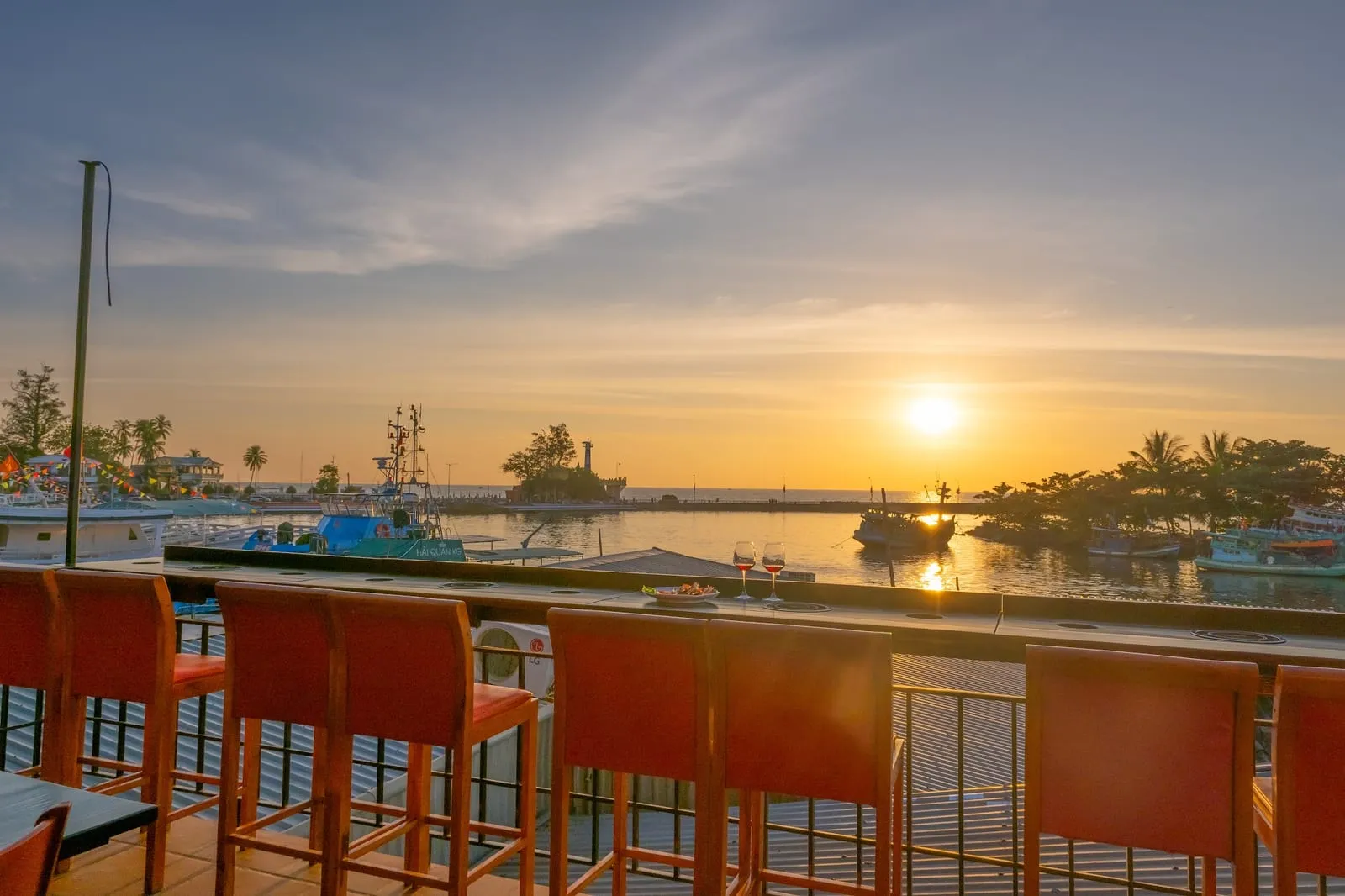 A restaurant terrace overlooking the Duong Dong River at sunset